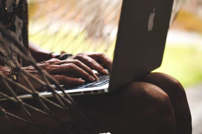 صورة لـ جهاز MacBook Air ساخن جدًا؟ أفضل النصائح والحيل لتبريده | Woman_using_a_MacBook_Air_on_her_lap-nbCJSPfs-DzTechs