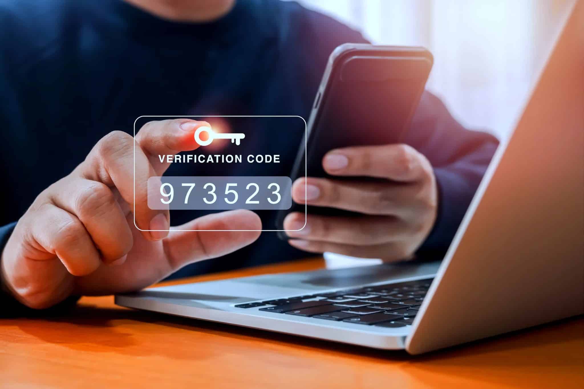 man entering two factor authentication code on smartphone