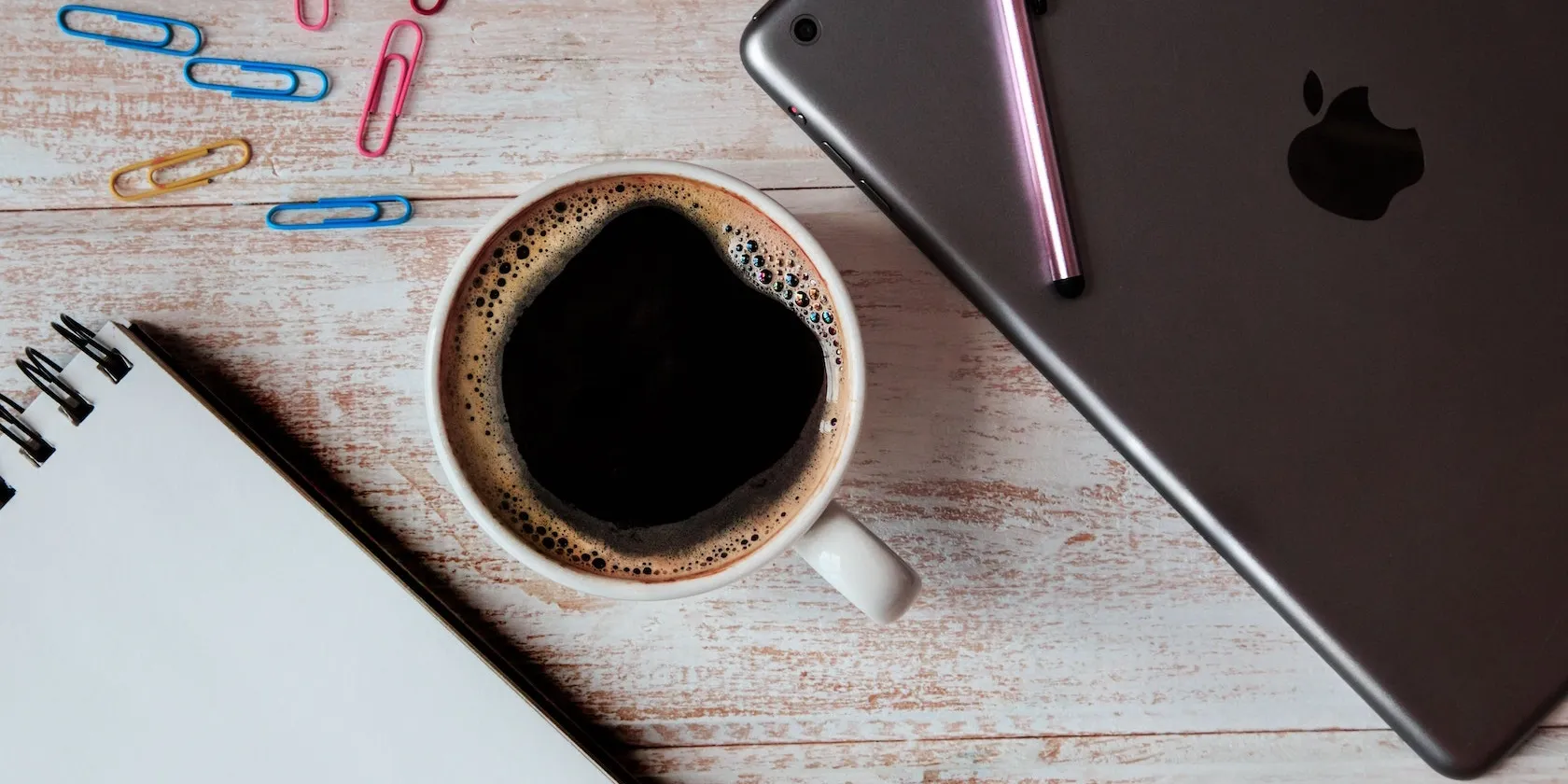 Coffee iPad and paperclips on table