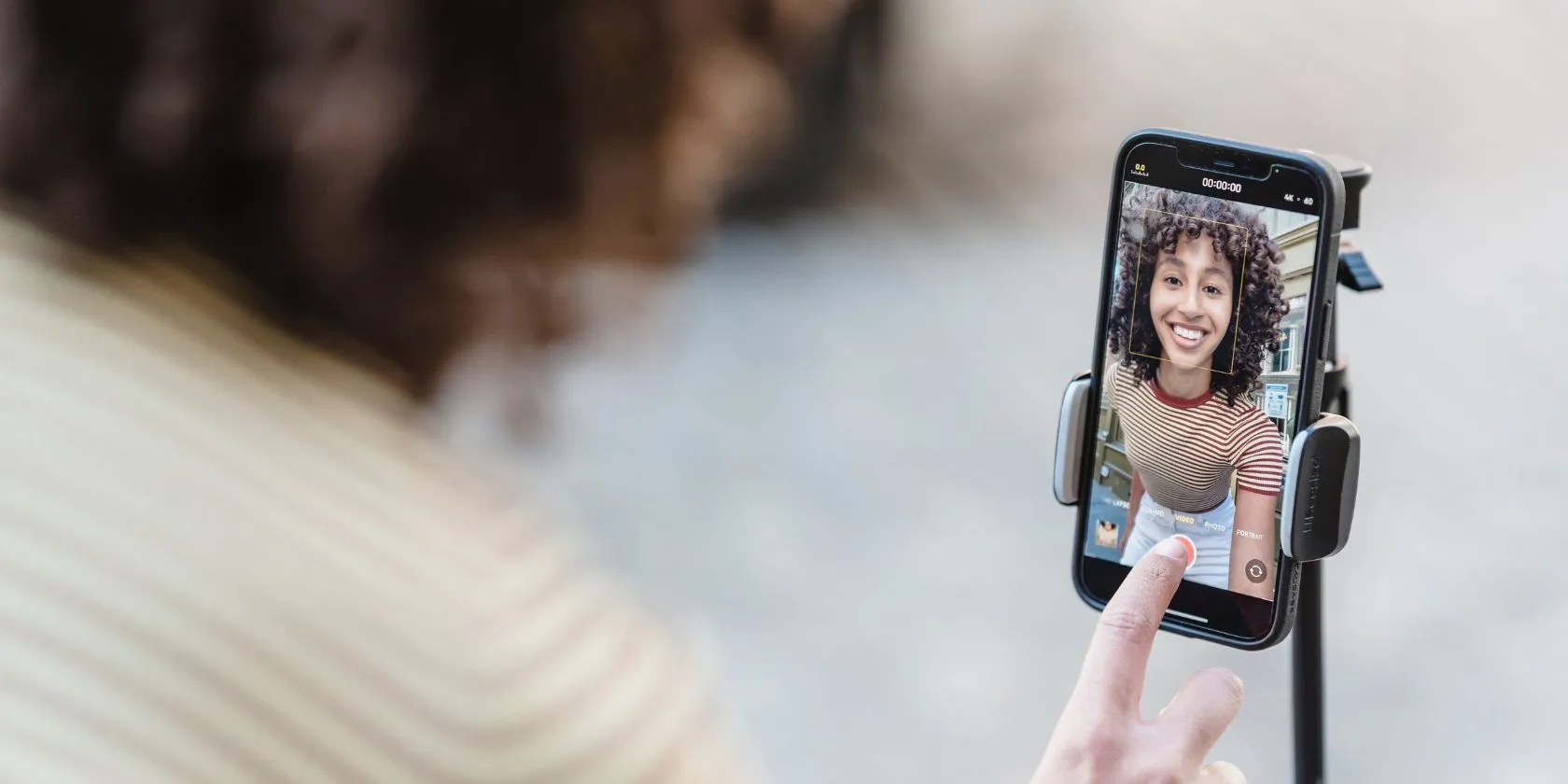Woman recording herself on a mounted smartphone
