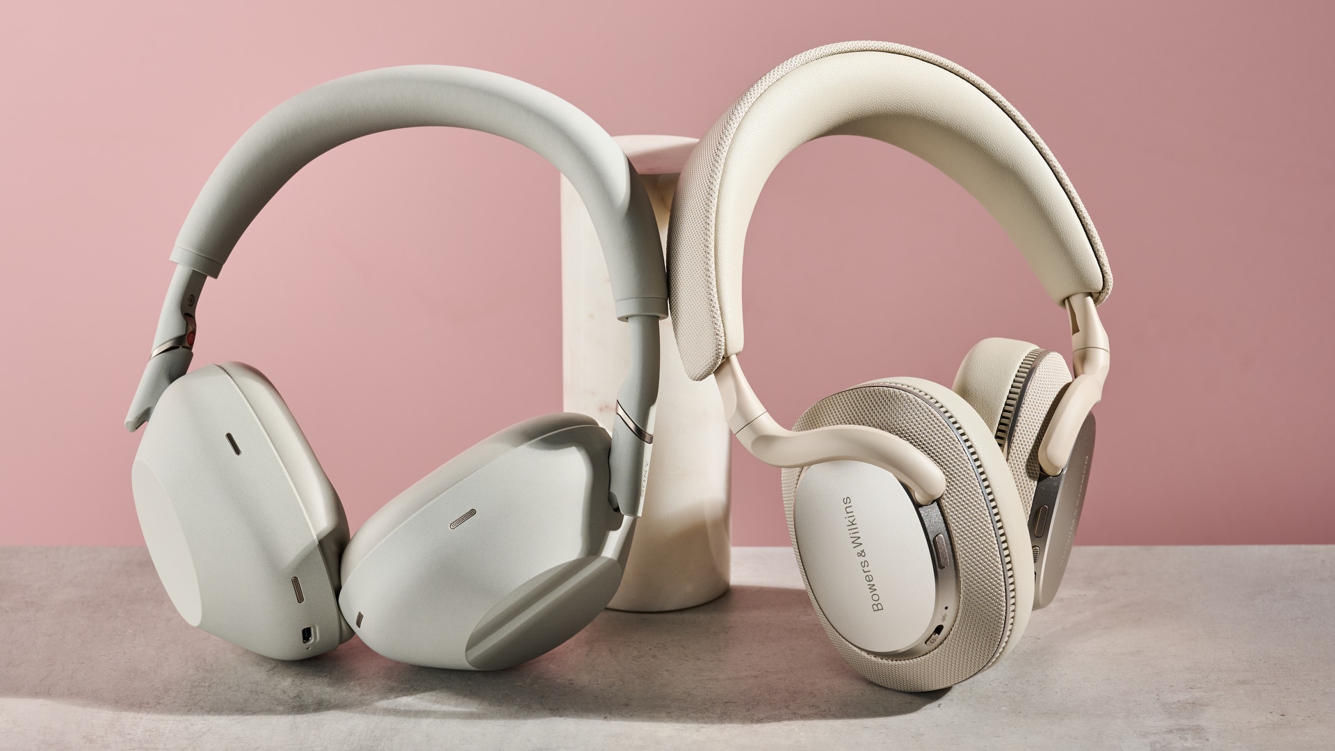 Sony WH-1000XM6 and Bowers & Wilkins Px7 S3 leaning against pole