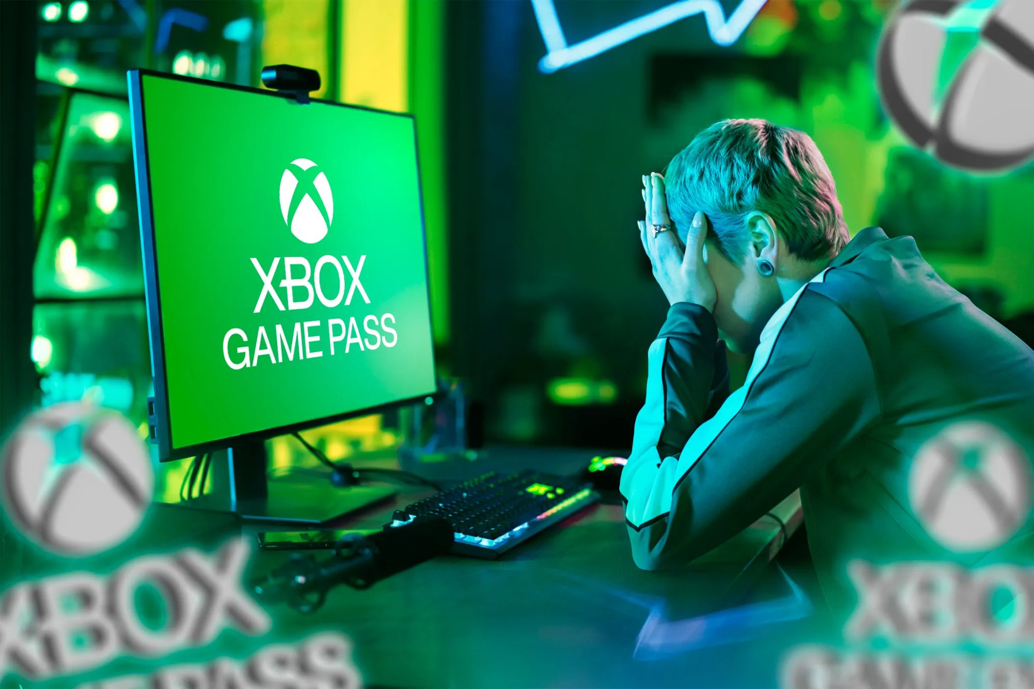 A frustrated person using a pc with the Xbox Game Pass logo on the screen.