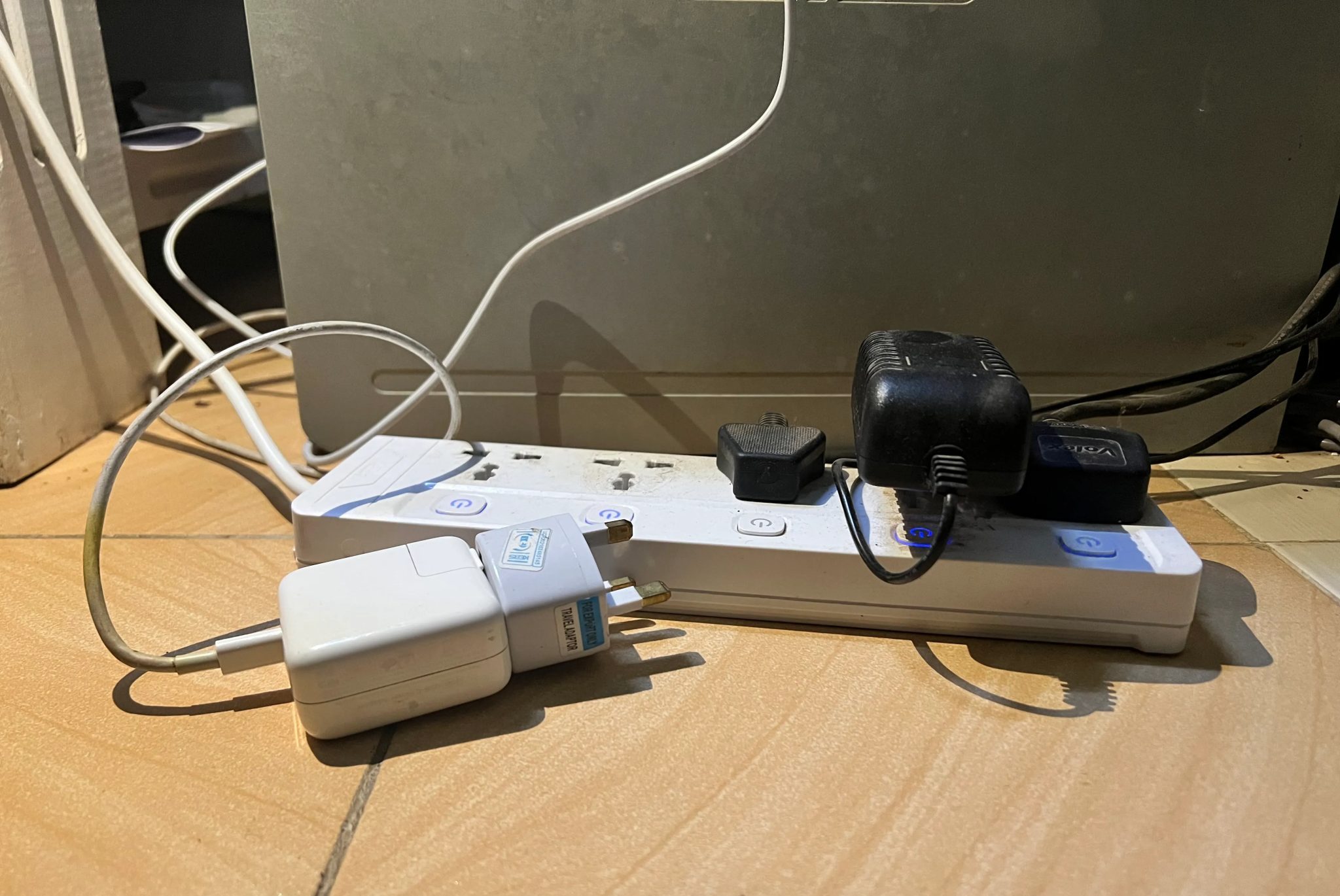 A laptop charger unplugged from a power strip