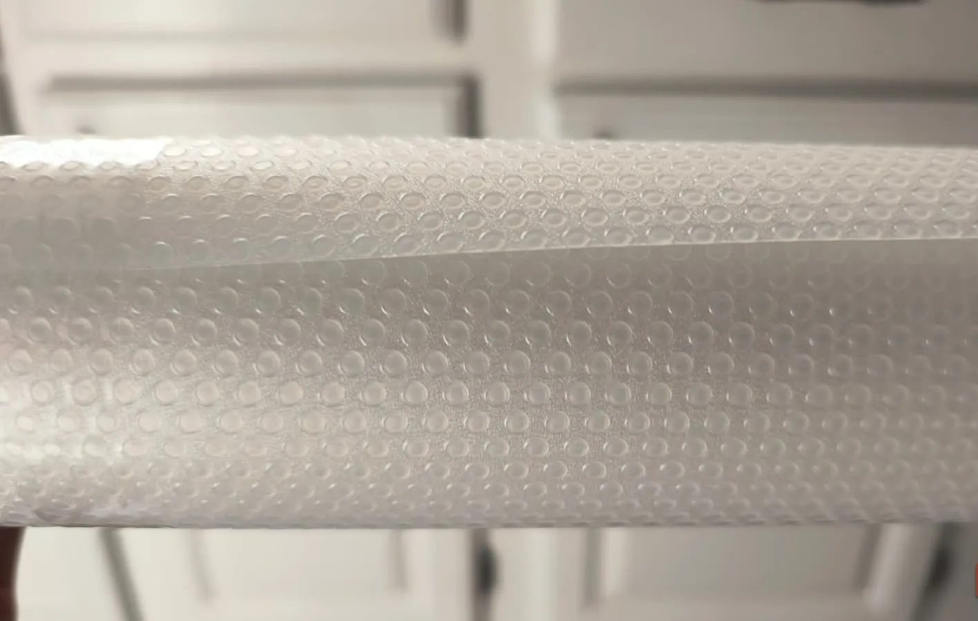 Close up side view of a plastic liner roll