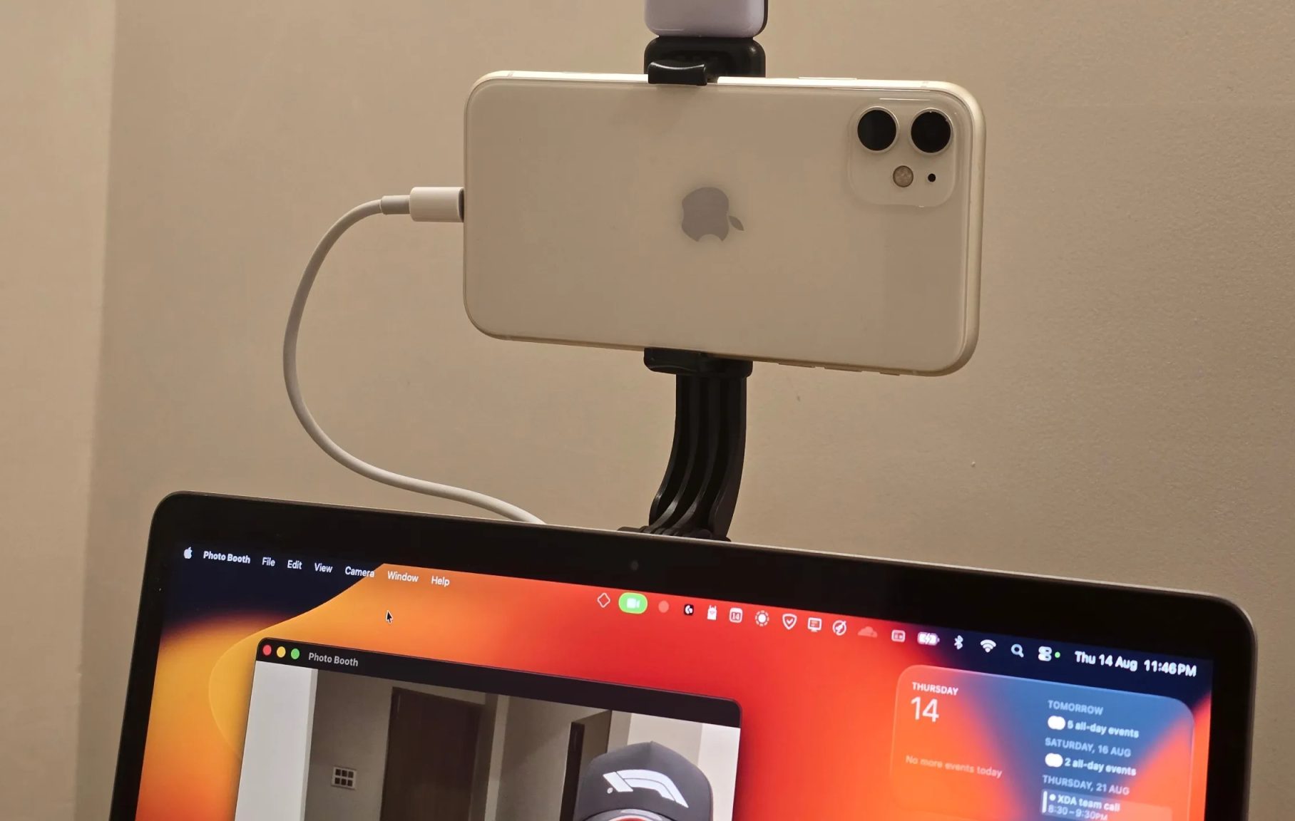 iPhone being used as a webcam mounted on top of a MacBook