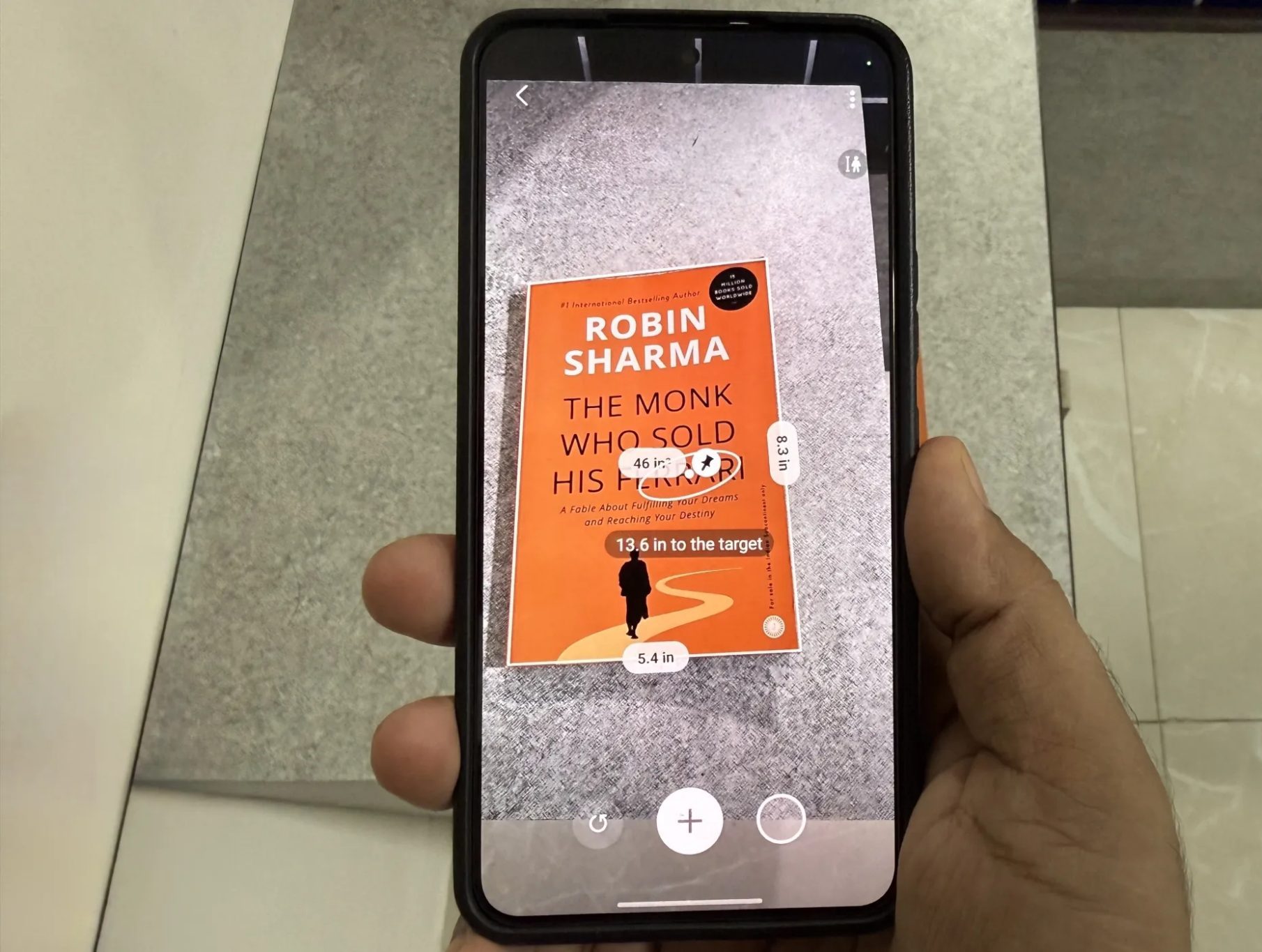 Samsung phone showing Quick Measure app measuring a book