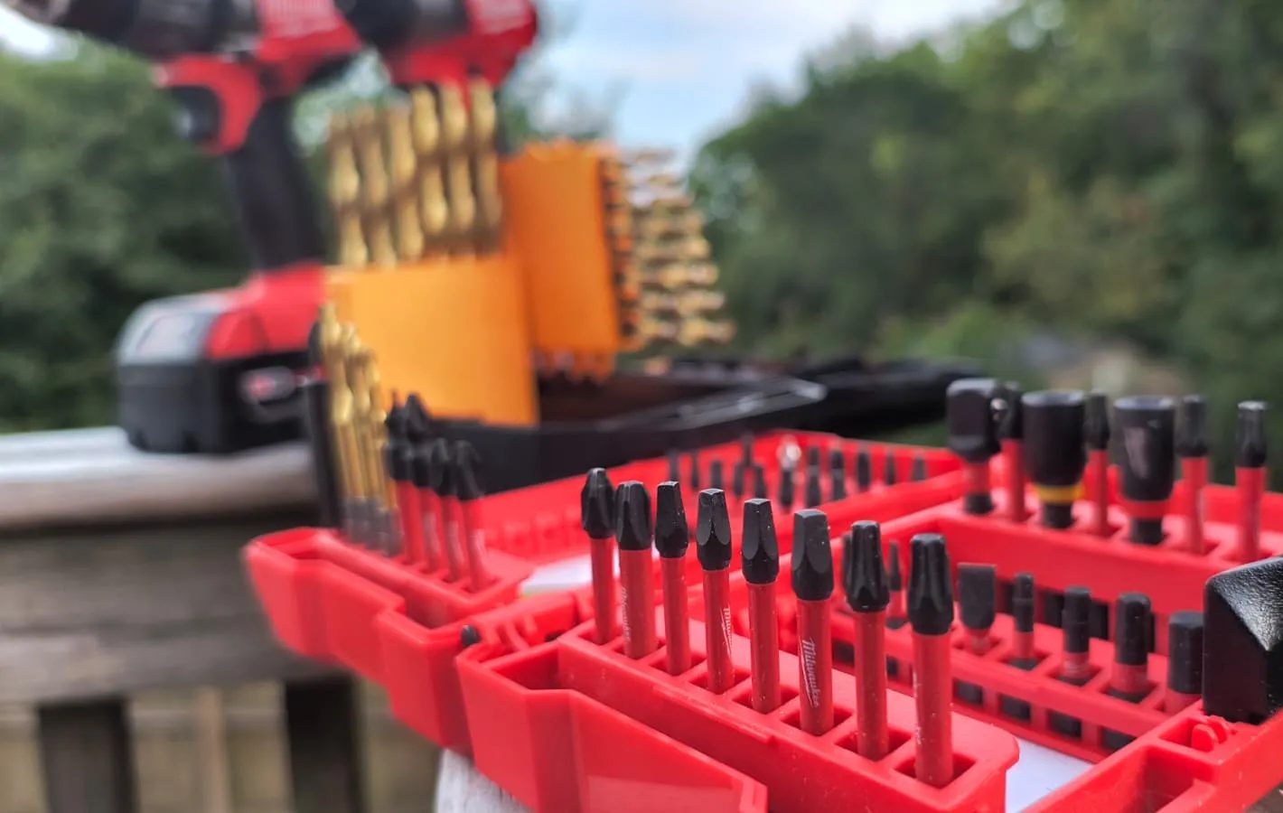 Drill and driver bits on a wooden rail