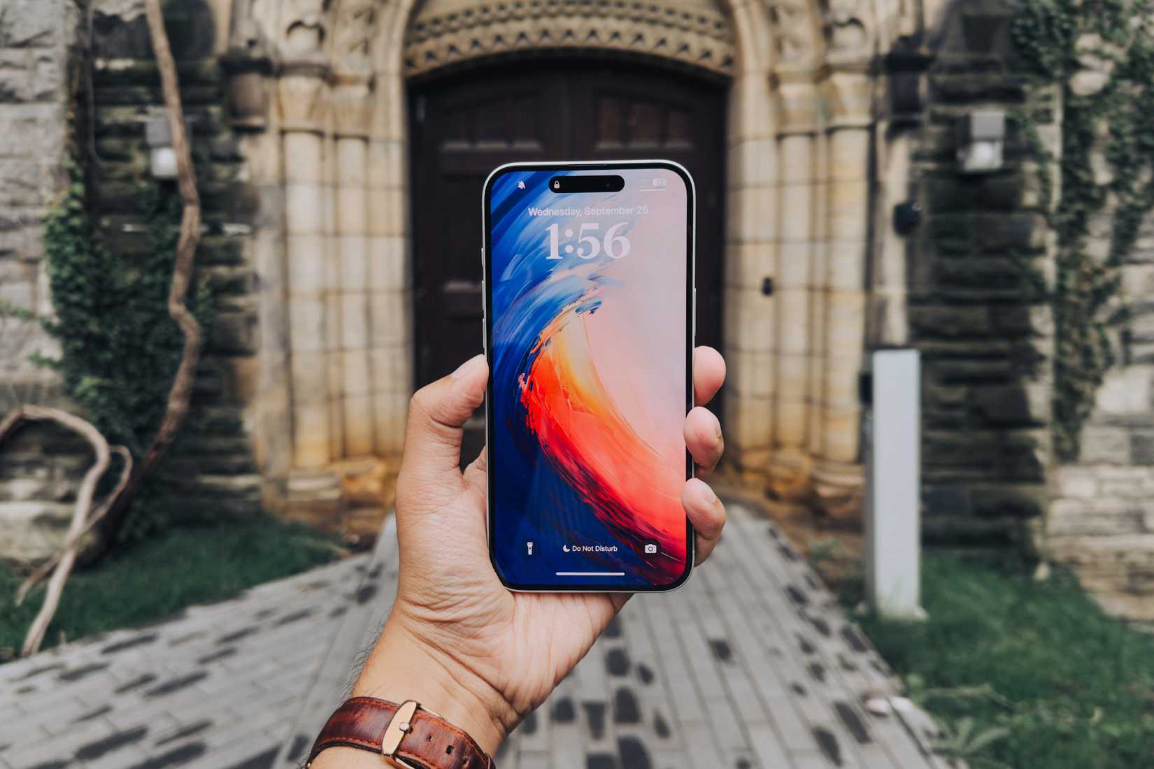 iPhone 16 Plus in hand screen side facing