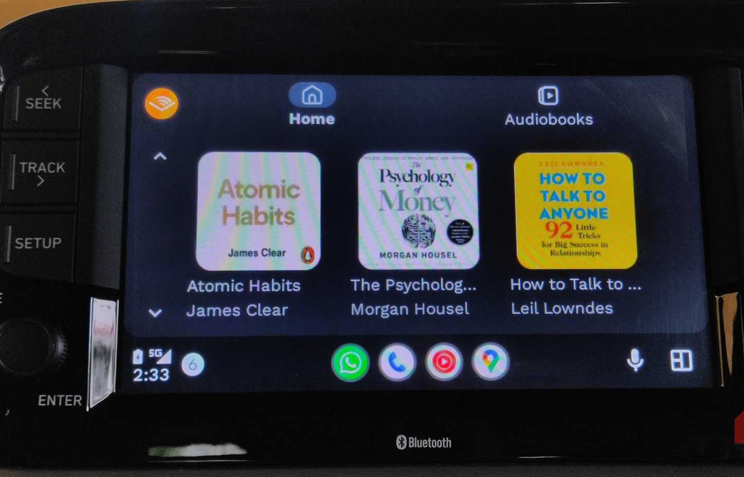 Audible app home screen with multiple books visible on Android Auto.