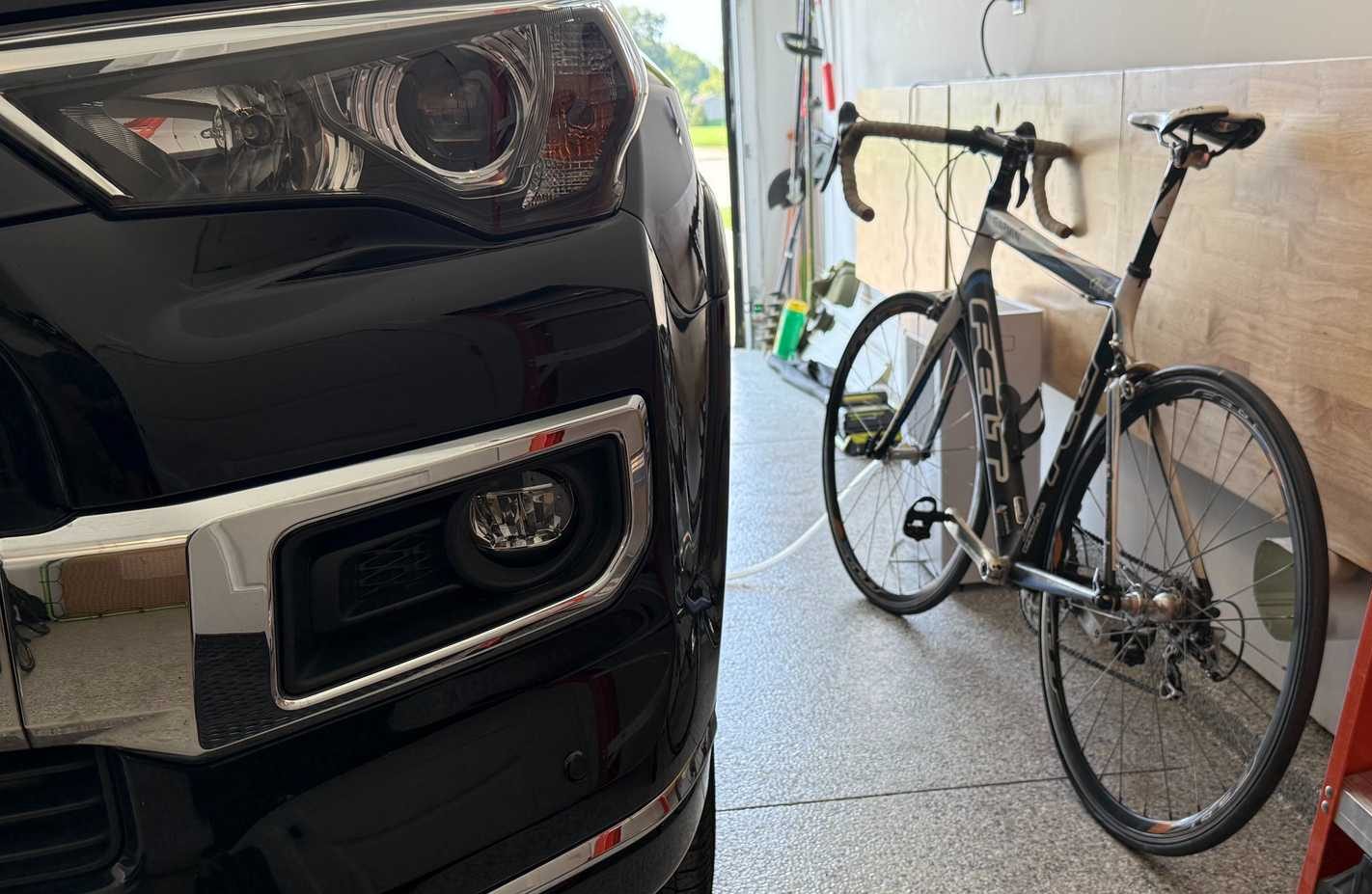 bike next to black car in garage