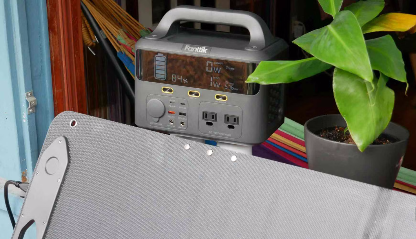 Fanttik EVO 300 power station and solar panel on window sill close up