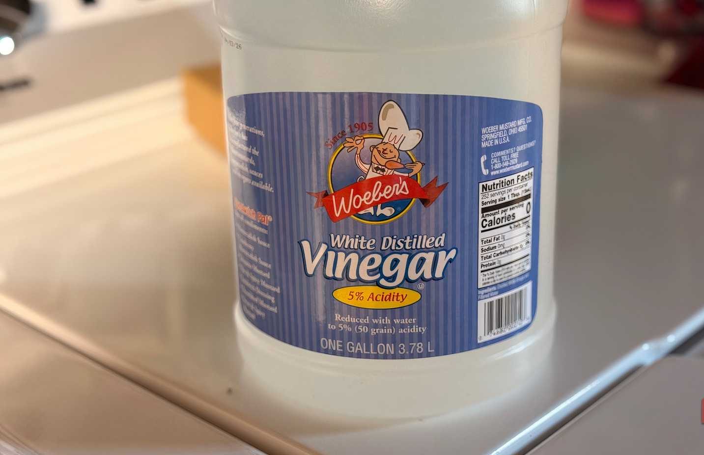 زجاجة خل موضوعة أعلى غسالة ملابس.