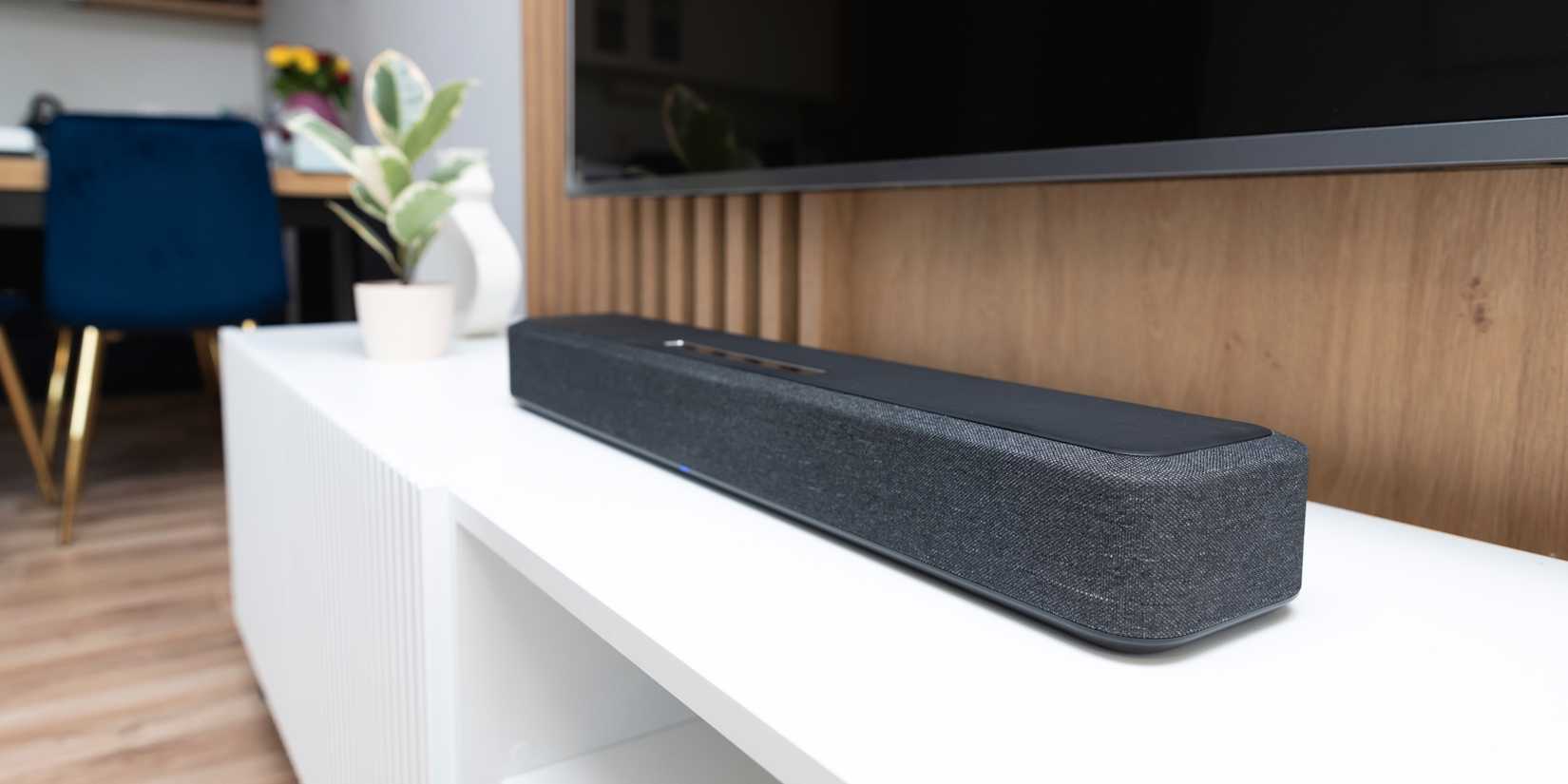 soundbar on tv unit under large screen